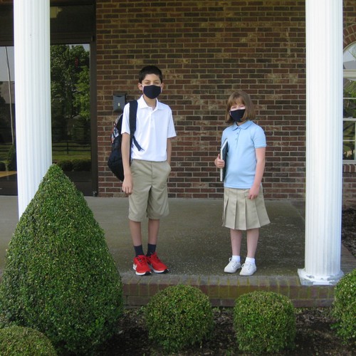 Boy and girl models wearing French Toast schoolwear, including masks