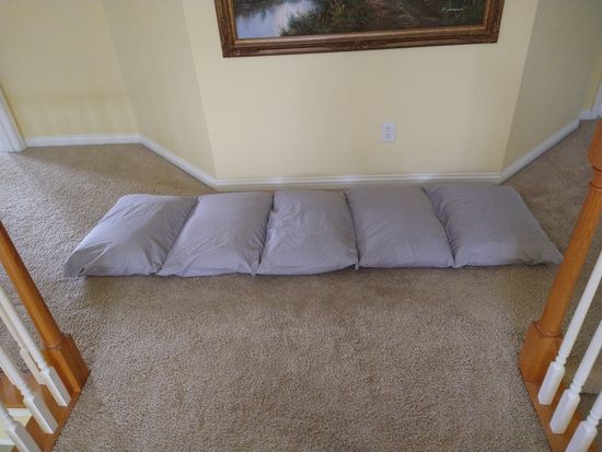 sideways view of pillow mattress on floor