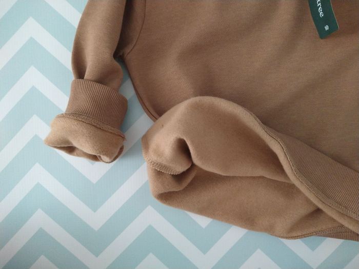 Detail showing part of the soft interior of the tentree organic cotton toddler sweatshirt
