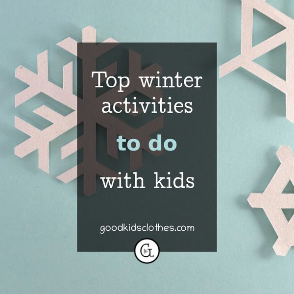 paper snowflakes on a light blue background - winter activity ideas with kids