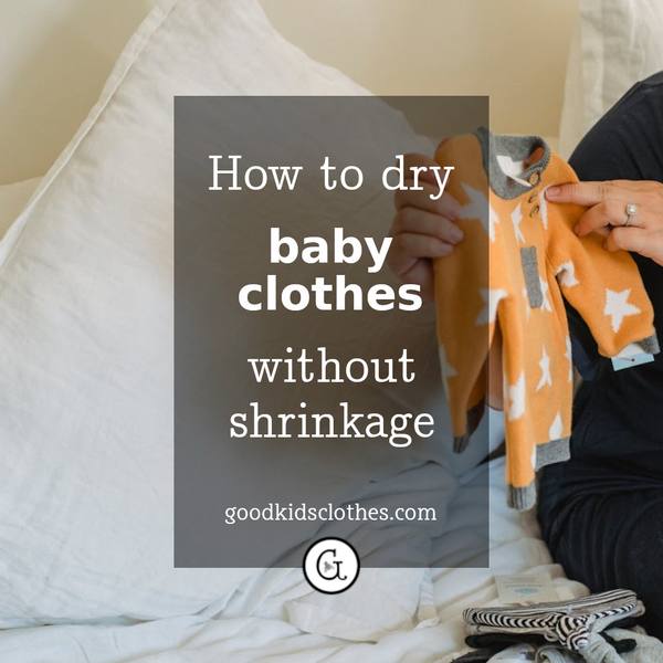 Woman holding baby clothing up